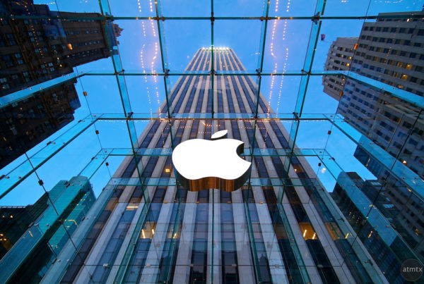an up-angled view of the Apple logo on the company's NYC flagship store