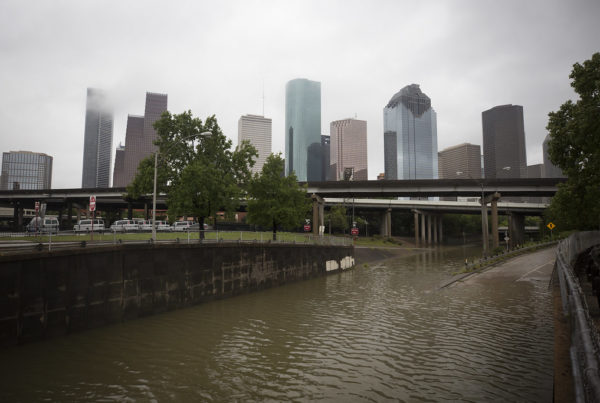 a view of the Houston skyline with flood waters rising