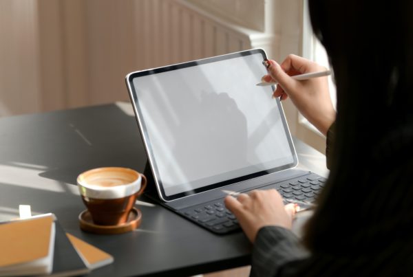 person using tablet and keyboard