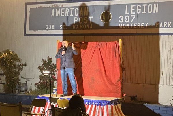 Comedian Fernando Sanchez on a podium at an American Legion post in Monterey Park, California..