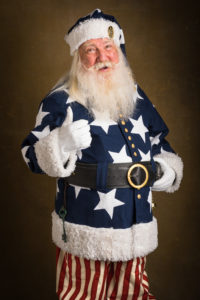 A man dressed in a santa claus cosutme with white stars and red stripes
