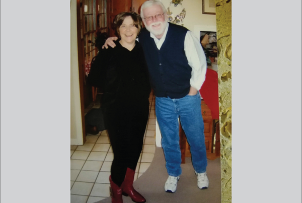 Barbara Anderson wearing her red cowboy boots, standing next to her husband Jim