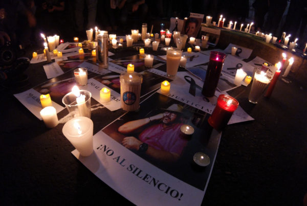 candles and flyers with image of slain Mexican journalist Javier Valdez