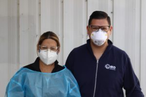 a doctor and a health care worker wearing face masks