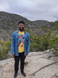 a man standing above a canyon