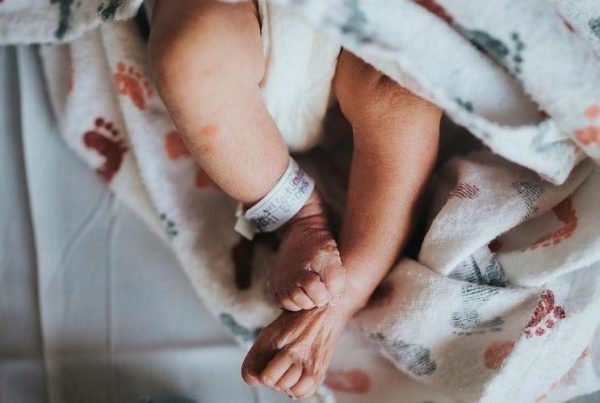a photo of the legs of a young baby wrapped in a blanket