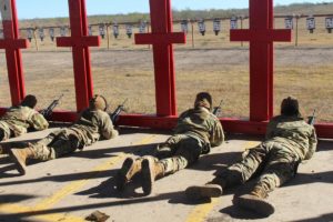 military trainees laying down on a rifle range