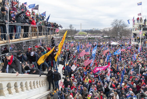 a large gathering of pro-Trump protesters with flags in Washington D.C.