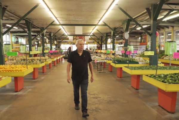 Chef Medrano walks through a marketa, full of vegetables.