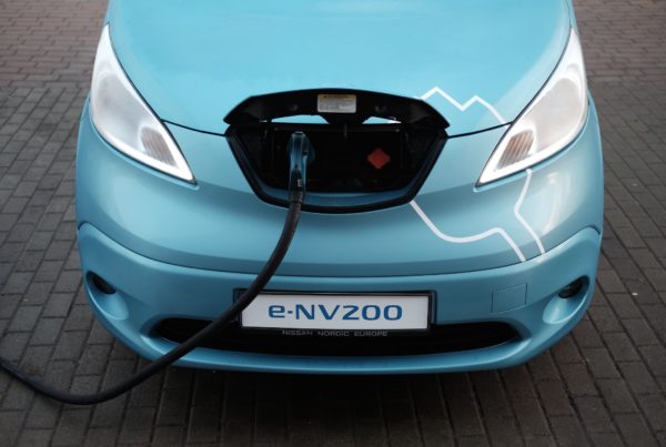 the front end of an elecritc car, with a cord coming out of it
