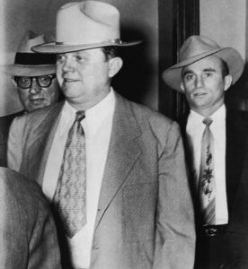 a vintage photo in black and white with three men wearing suits and hats
