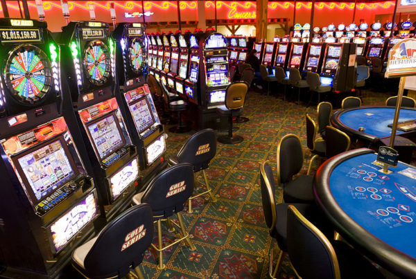 a casino floor with slot machines and poker tables