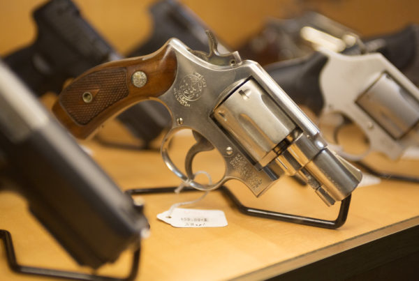 pistols in a gun shop display case
