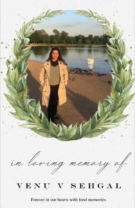 a remembrance card with the picture of a woman standing by a lake framed with a graphical wreath