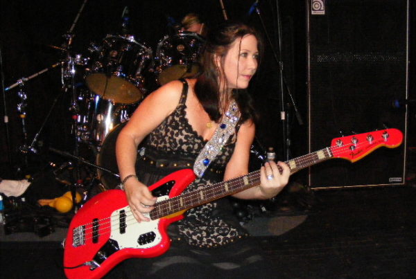 Kathy Valentine plays bass on stage