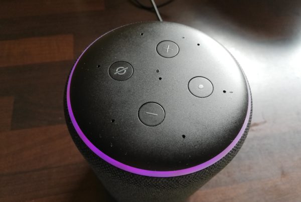 an Amazon echo dot speaker gows purple