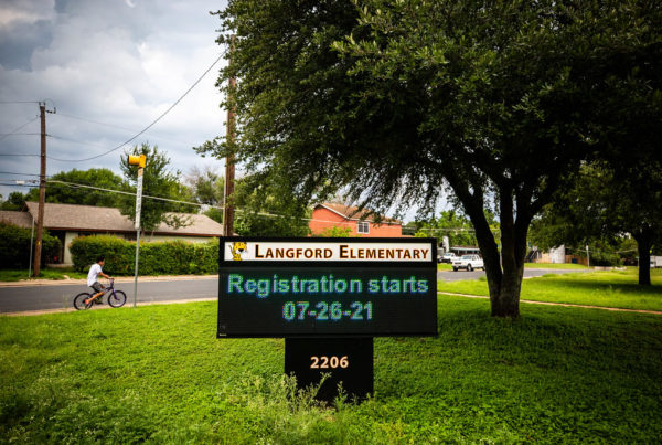 a sign outside an elementary school says "registration starts July 26."