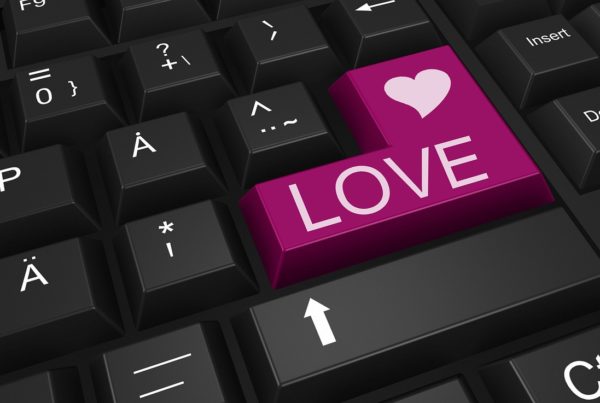 closeup of computer keyboard keys, one of which is labeled Love, with a heart on it