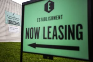 A large sign that says "Now leasing."