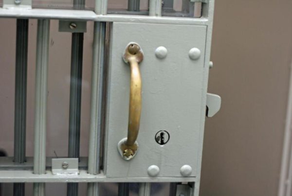 closeup of the door handle of a jail cell