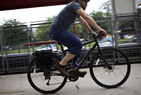 a cyclist pedals past a camera