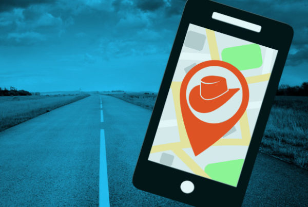 Illustration: In the foreground, a cell phone with a navigation icon it. Behind it, a road stretching off into the distance