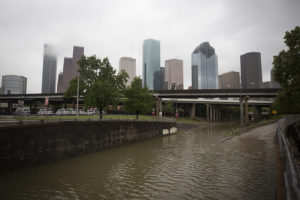 The Houston skyline in the background, flood waters in the foreground