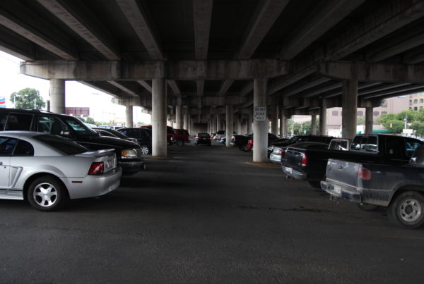 looking down a row of cars in a parking garage in Austin