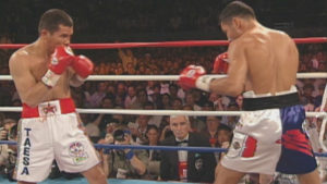 a still image from a boxing match from the 1990s between Oscar De La Hoya and Julio César Chávez