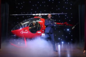 a small helicopter sits on a stage with fog underneath