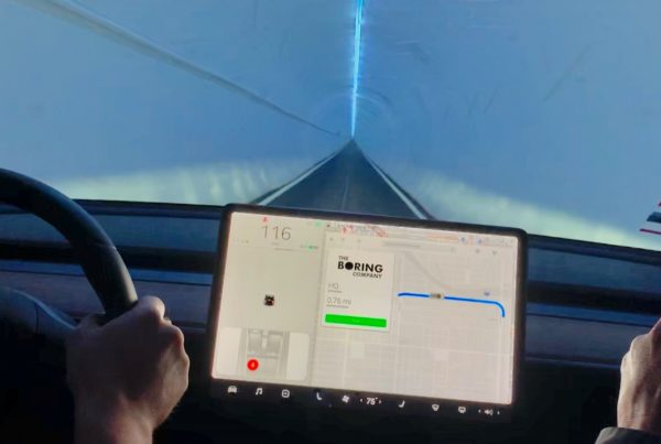 inside a Tesla, the image shows the driver control screen, which says "Boring" and a view through the windshiled.