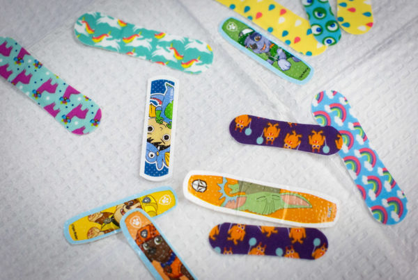 a collection of colorful, printed band aids await use