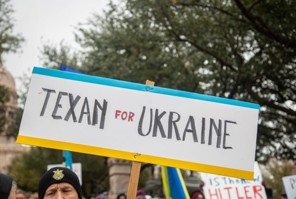 People hold a large sign that says "Texan for Ukraine"