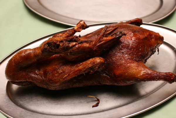 a plate containing a cooked Peking duck