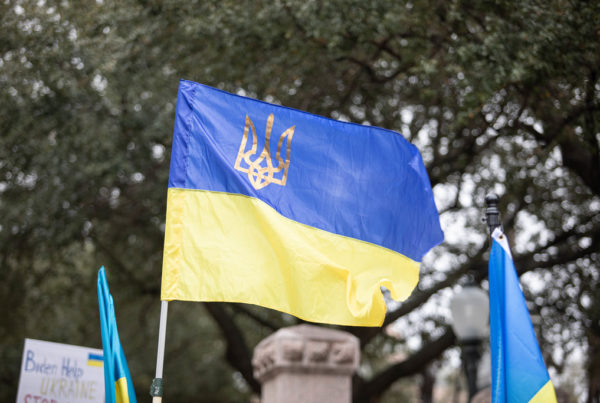 Supporters of Ukraine hold a large Ukranian flag.