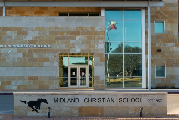 a modern-looking stone building with a sign out front reading "Midland Christian School est 1957"