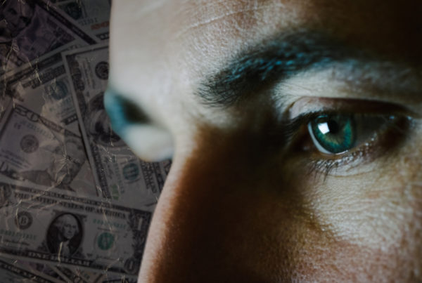 a close up photo of a person's concerned eyes with a background of money