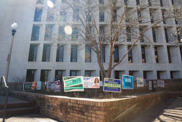 Campaign signs in front of an office building that's serving as a polling place.