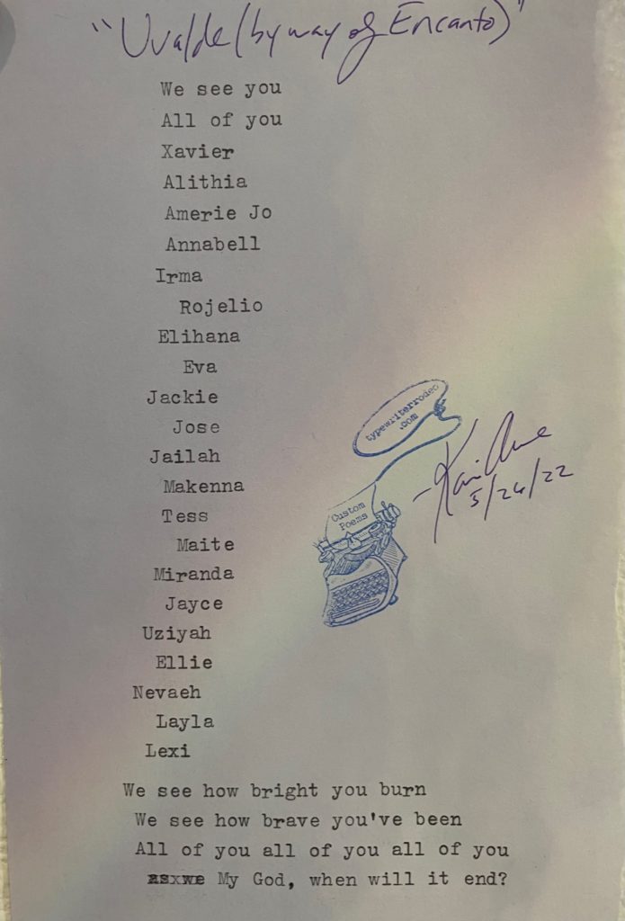 a photo of the typewritten poem on a torn piece of lavendar paper with the slight tinge of a rainbow breaking through the middle of it