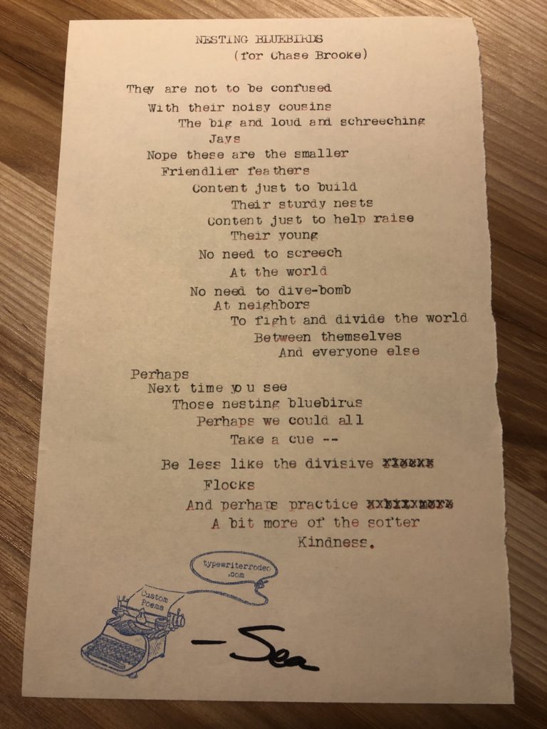 A photo of the typewritten poem on a torn half sheet of yellowish paper. The paper is signed and stamped.