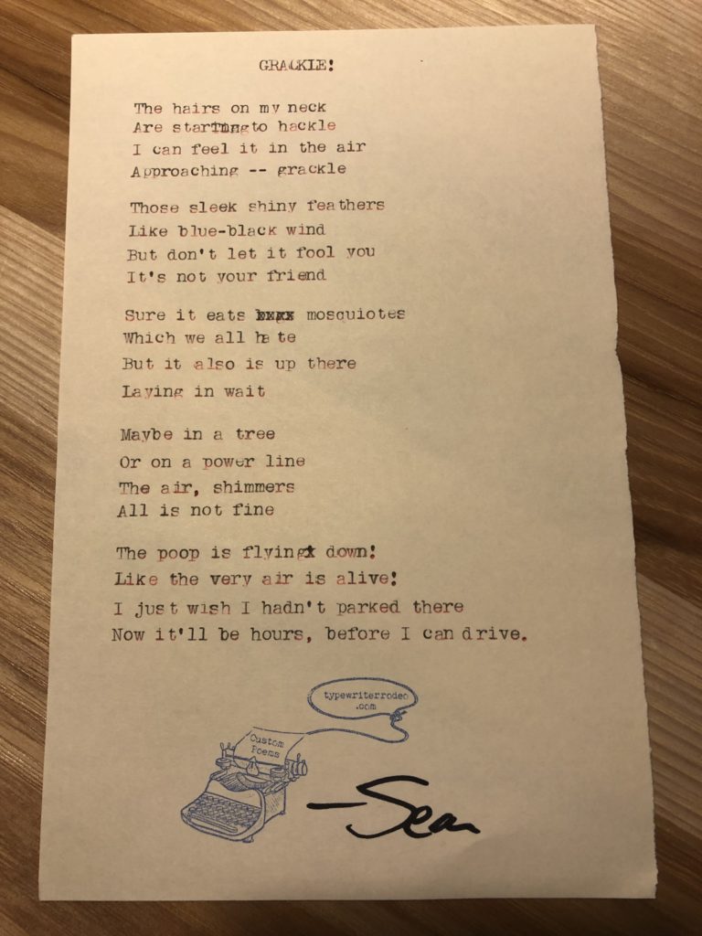 A photo of the typewritten poem on a torn piece of yellow paper