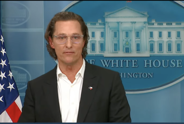 Actor Matthew McConaughey in front of the White House seal and an American flag