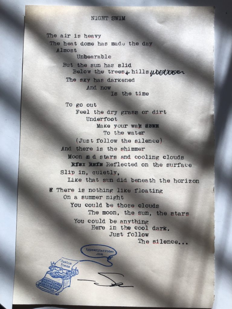 the sun shining through blinds casts a shadow on a photo of the typewritten poem on a half sheet of paper