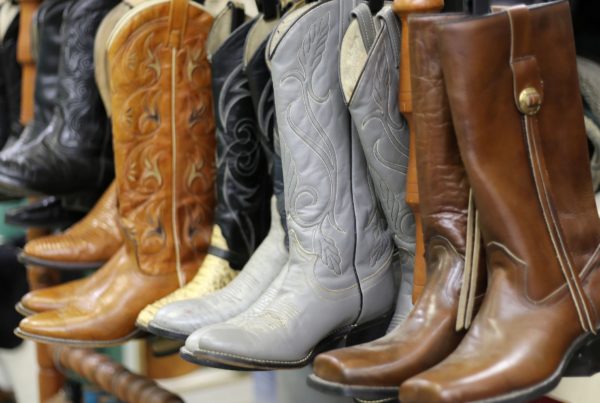 a close-up photo of five pairs of vintage cowboy boots in different shapes and colors