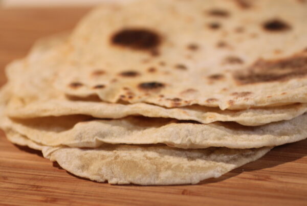 a close-up of a stack of fresh flour tortillas