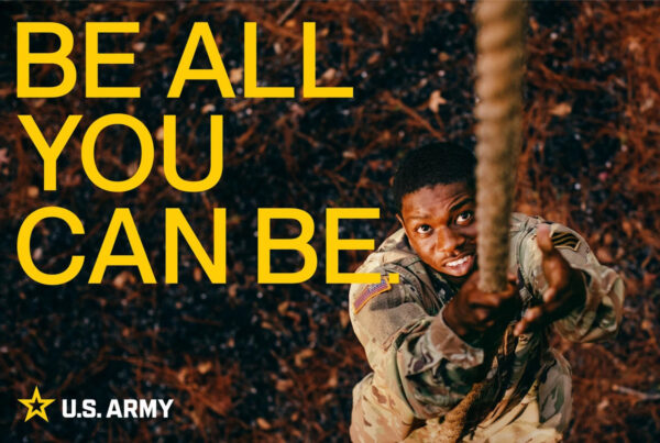 An ad from the U.S. Army shows a recruit dressed in fatigues climbing a rope. The phrase "Be all you can be" is written in all caps in the lefthand corner of the image, with the army logo in the bottom left underneath it.