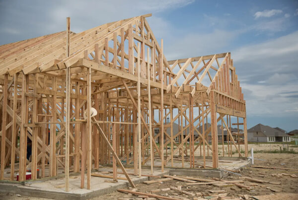 The wooden frame of a house under construction is seen.