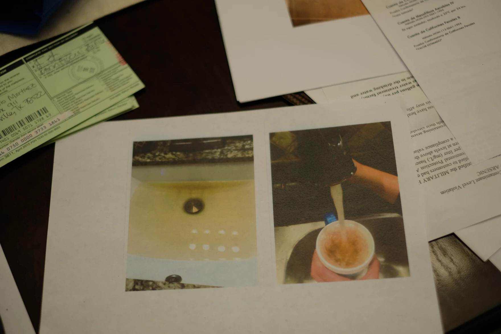 A paper is seen on which two photos are printed, both showing brown-tinged water.