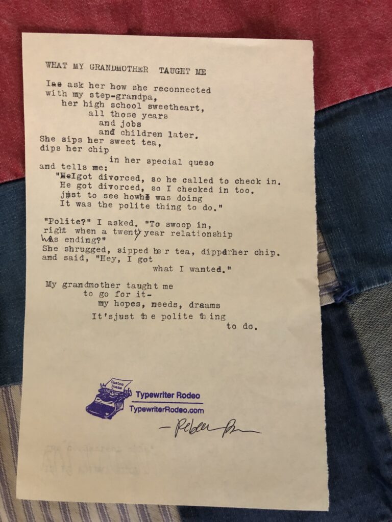 a photo of the typewritten poem on a torn half sheet of yellowish paper. the paper is sitting on a quilt.