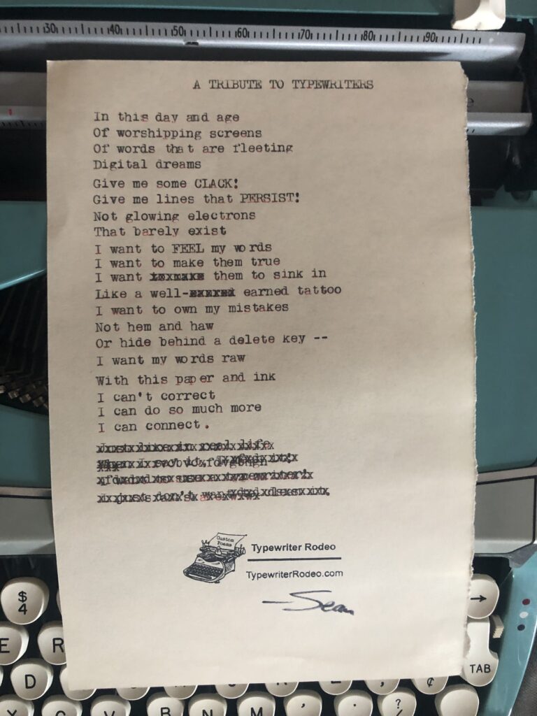 A photo of the typewritten poem on a torn half sheet of yellowish paper. The paper rests on a teal vintage typewriter